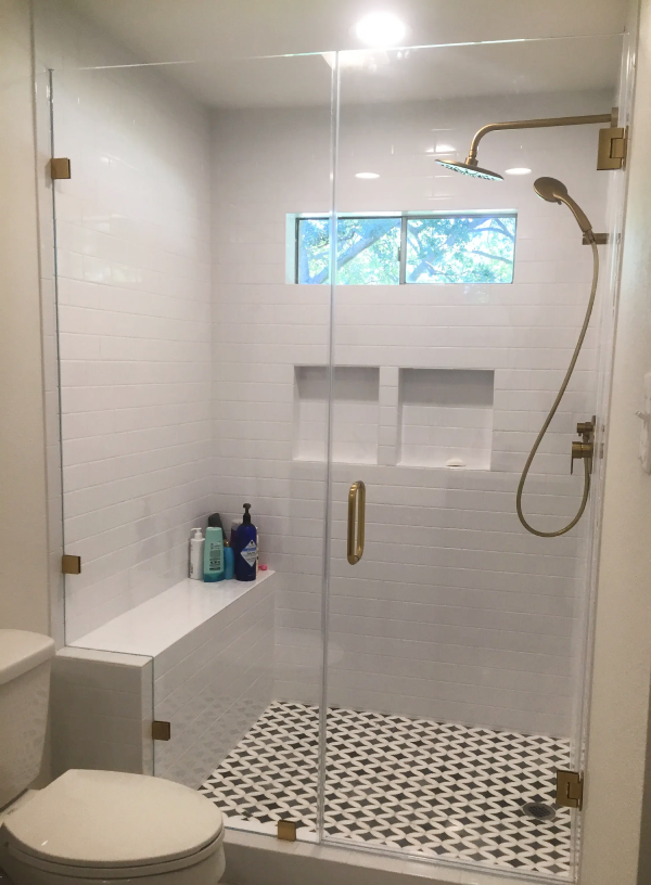 Bathroom remodel with black and white tiled shower floor in University Park, TX